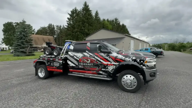 Transit Towing and Recovery tow truck wrapped by Ninja Graphics parked outdoors, displaying the detailed design work on the vehicle.